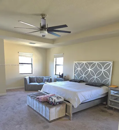 a bedroom with a bed couch and window