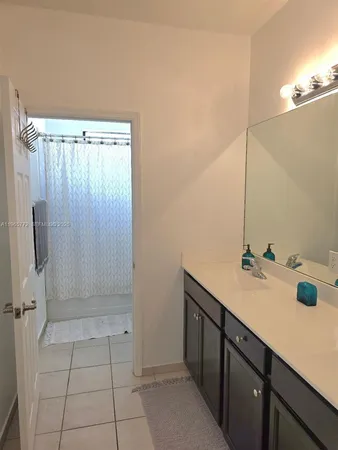 a bathroom with a sink and mirror