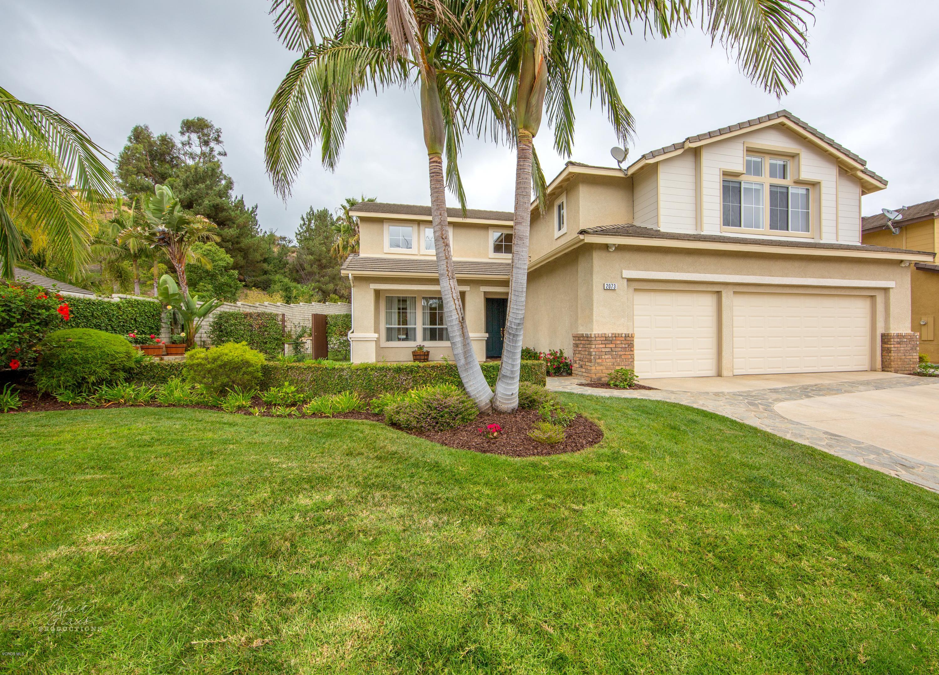 2073 Alborada Drive Camarillo, CA 93010 - Photo 3 of 51 a front view of a house with a garden and palm trees