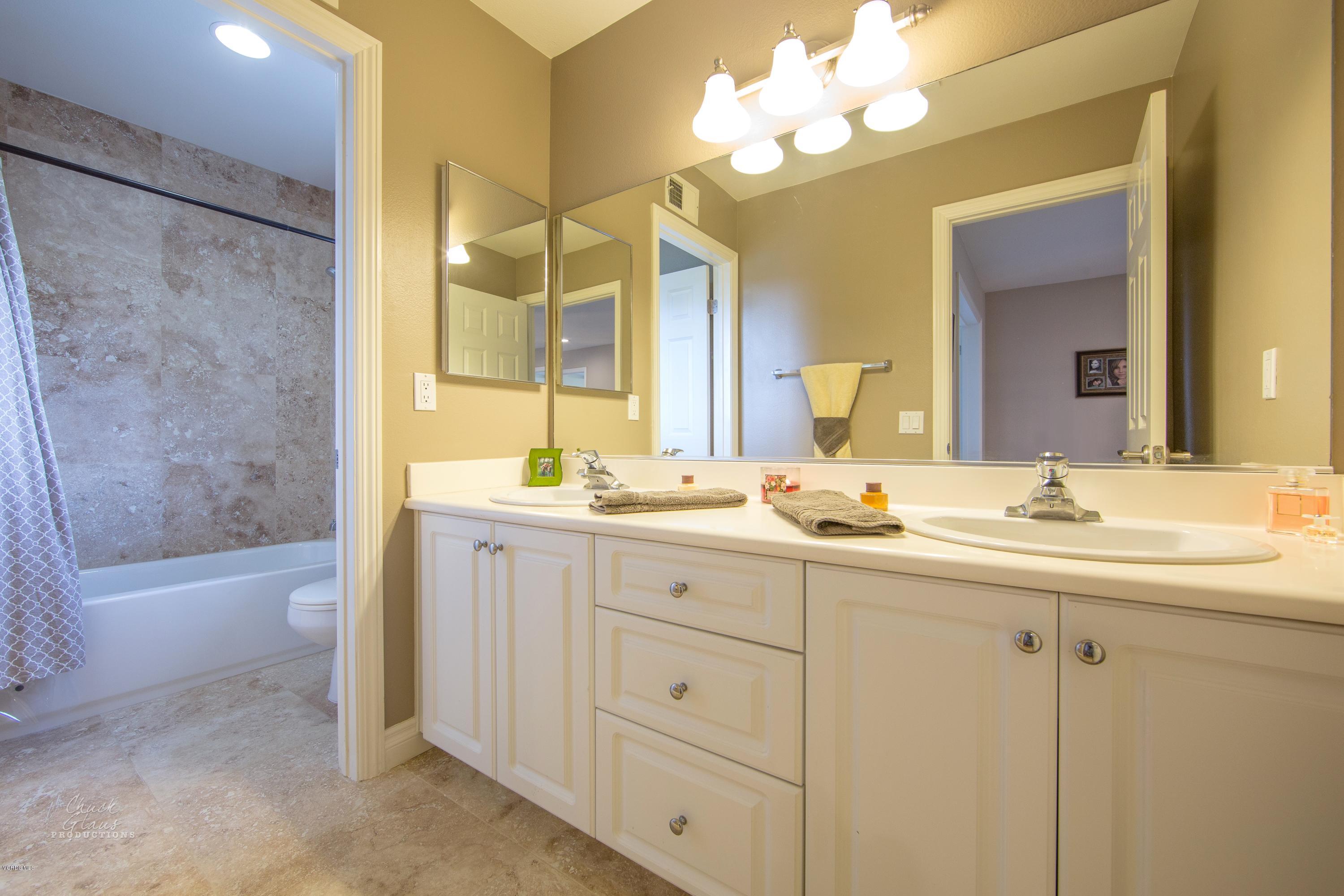 2073 Alborada Drive Camarillo, CA 93010 - Photo 32 of 51 a bathroom with a double vanity sink mirror and a bathtub