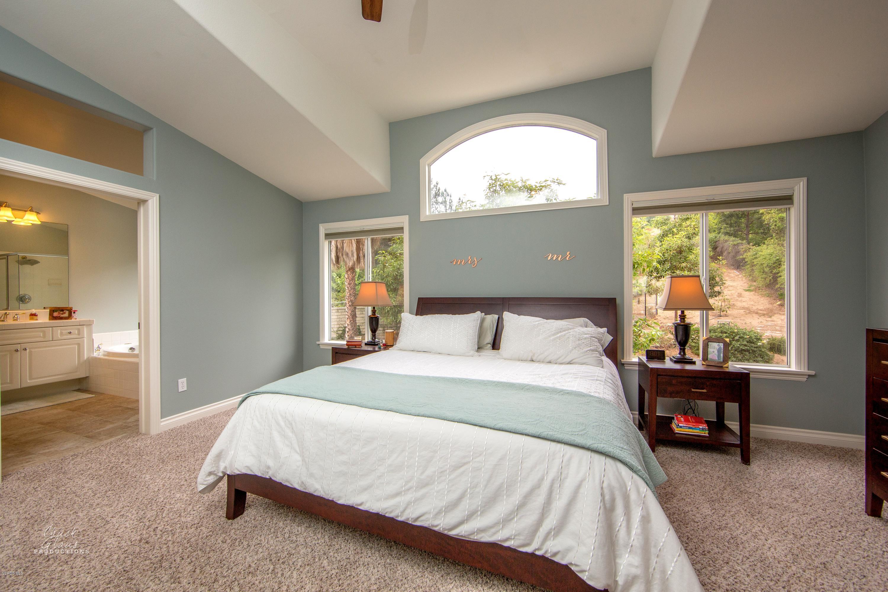 2073 Alborada Drive Camarillo, CA 93010 - Photo 37 of 51 a spacious bedroom with a bed and a chandelier