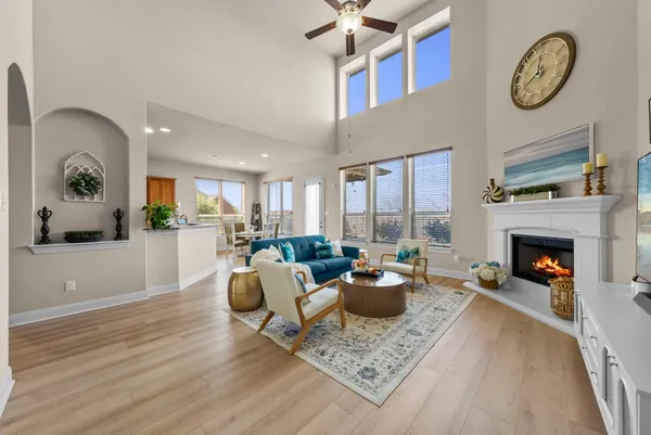 a living room with furniture a fireplace and a table