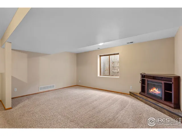 a view of an empty room with a fireplace