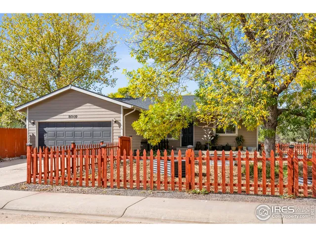a view of a house with a small yard and plants