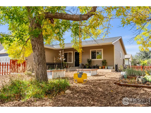 a view of a patio with dining table and chairs potted plants with wooden fence