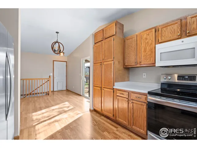 a kitchen with stainless steel appliances granite countertop a stove a refrigerator and a microwave