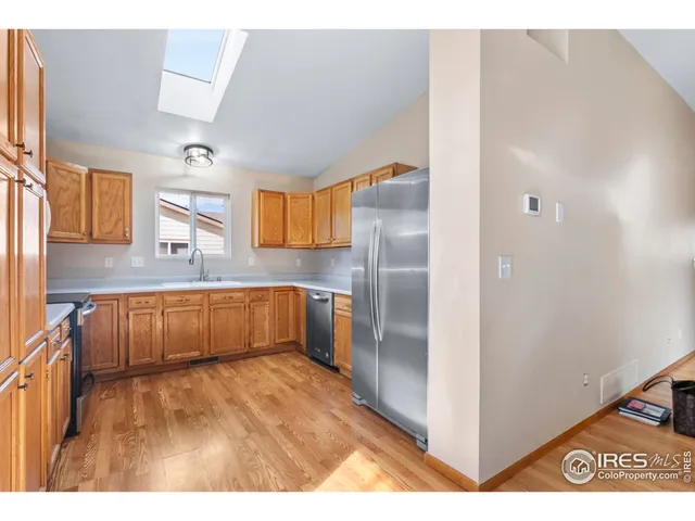 a kitchen with stainless steel appliances granite countertop a refrigerator and a sink