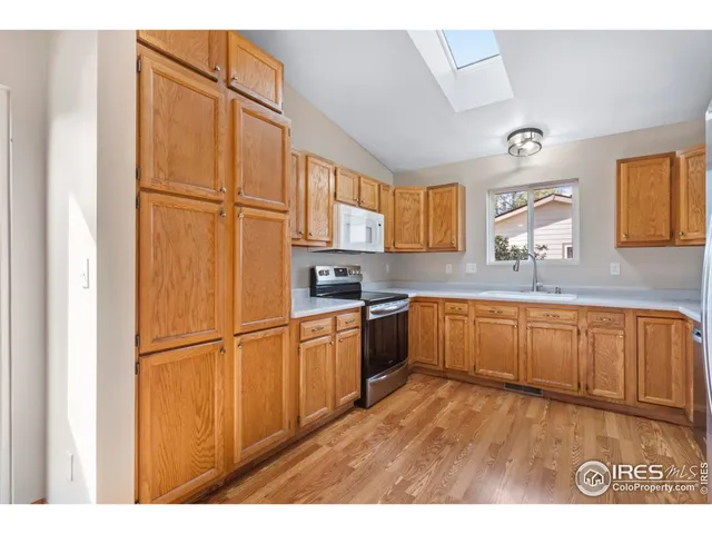 a kitchen with stainless steel appliances granite countertop a refrigerator sink and cabinets