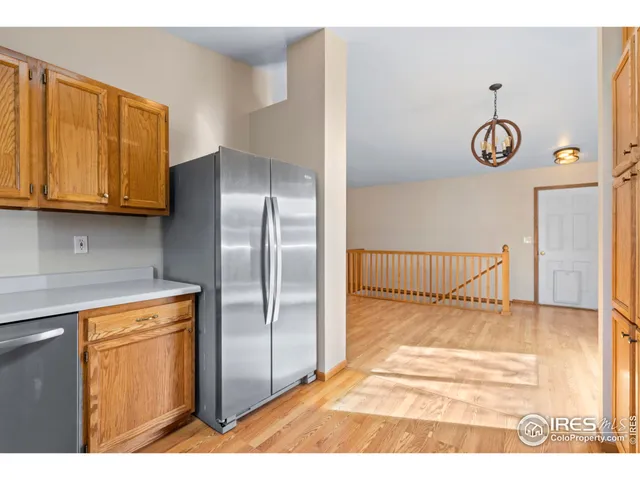 a view of a kitchen with wooden floor washer and dryer