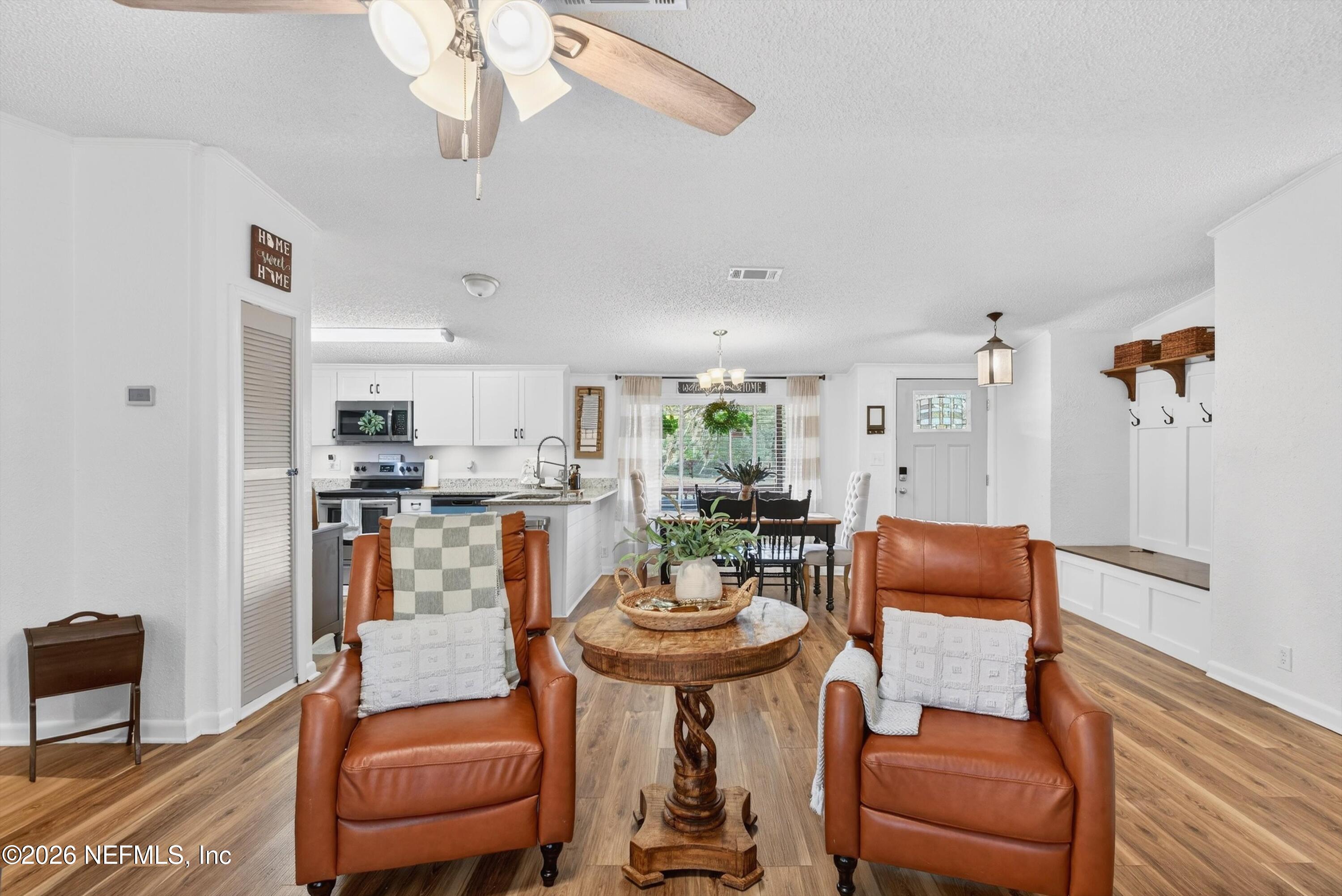 7655 Long Lake Road Keystone Heights, FL 32656 - Photo 14 of 58 a living room with furniture a rug and a chandelier