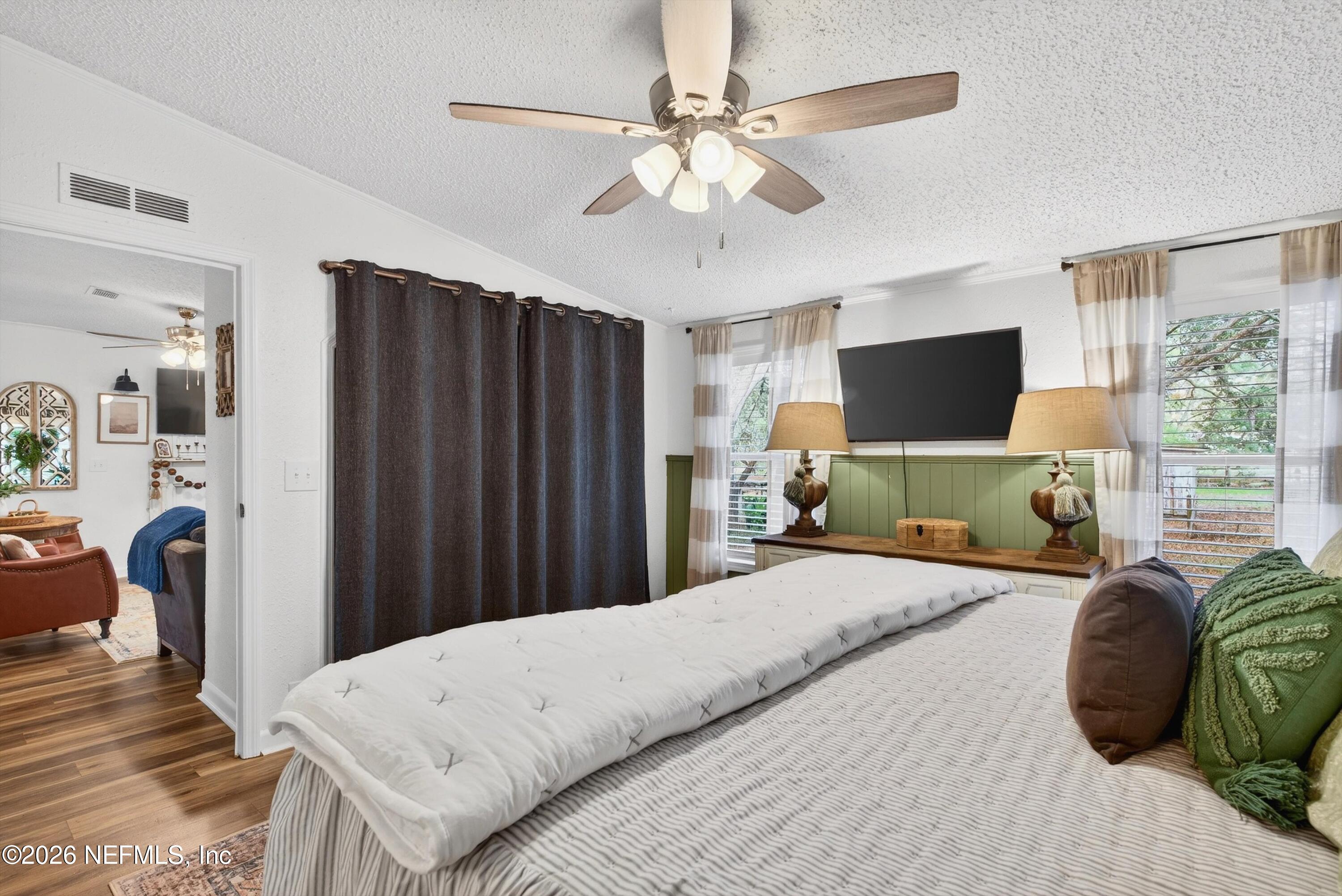 7655 Long Lake Road Keystone Heights, FL 32656 - Photo 19 of 58 a bedroom with a bed flat screen tv and a large window