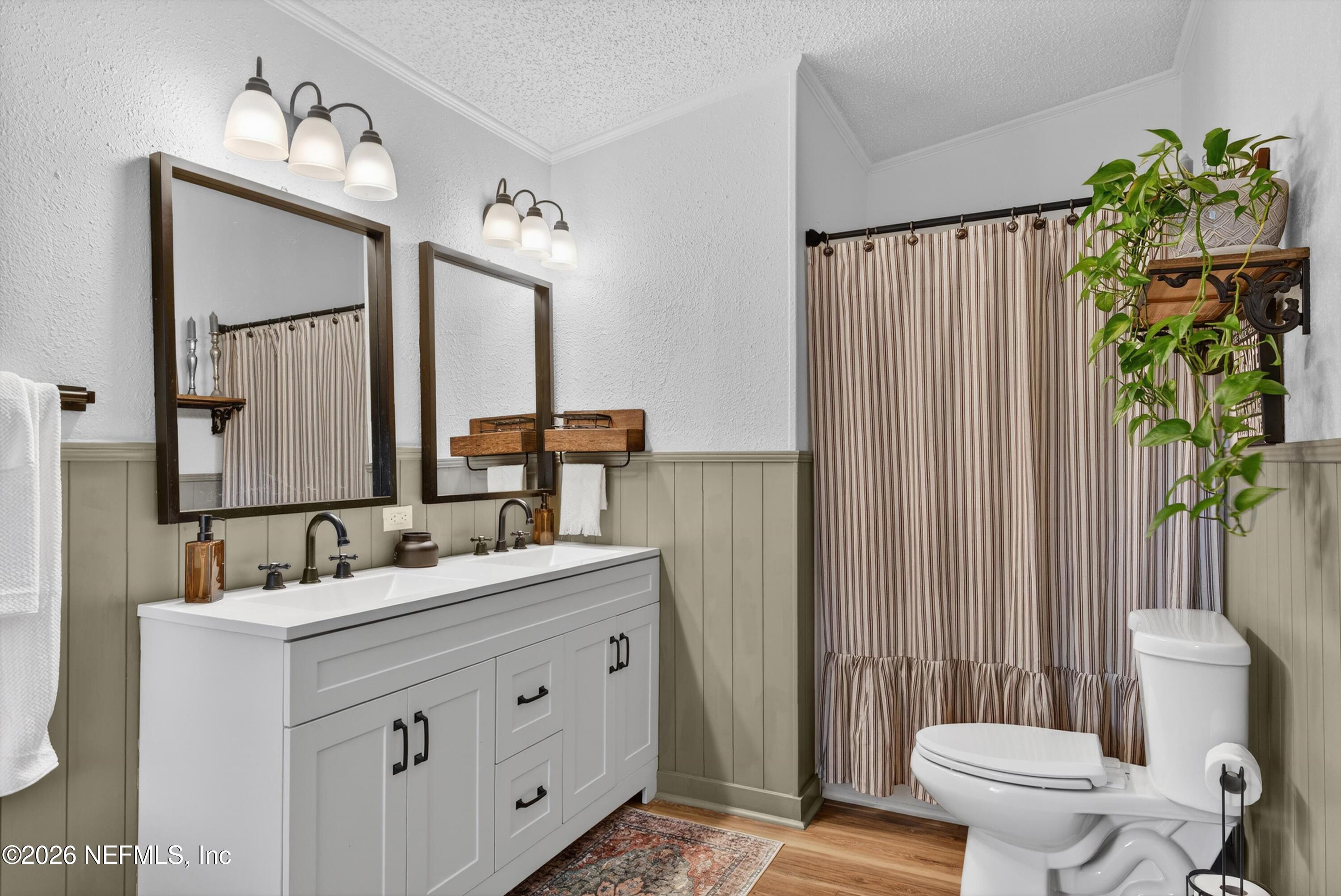 7655 Long Lake Road Keystone Heights, FL 32656 - Photo 21 of 58 a bathroom with a double vanity sink toilet and a mirror