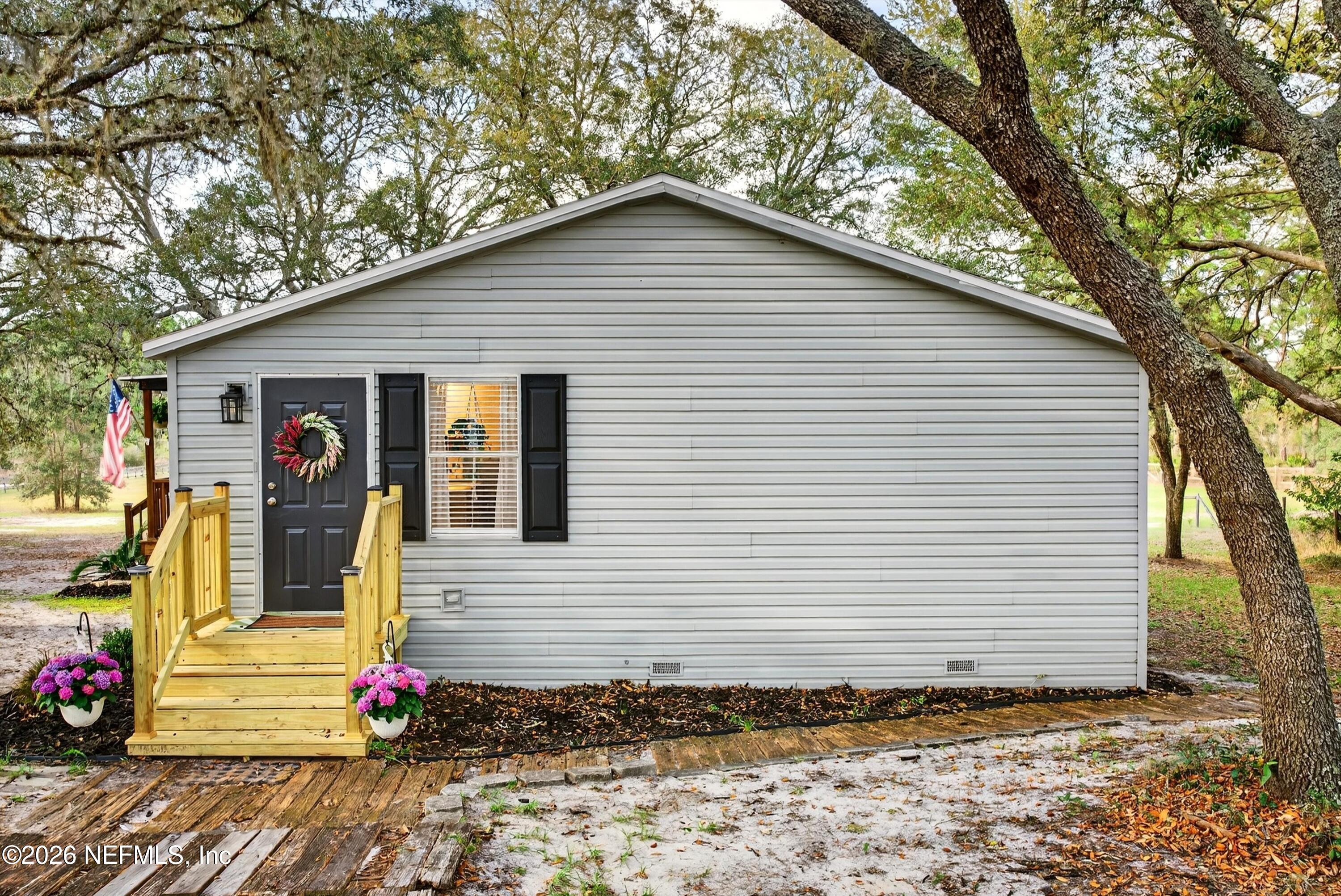 7655 Long Lake Road Keystone Heights, FL 32656 - Photo 31 of 58 a view of a house with a small yard and tree s
