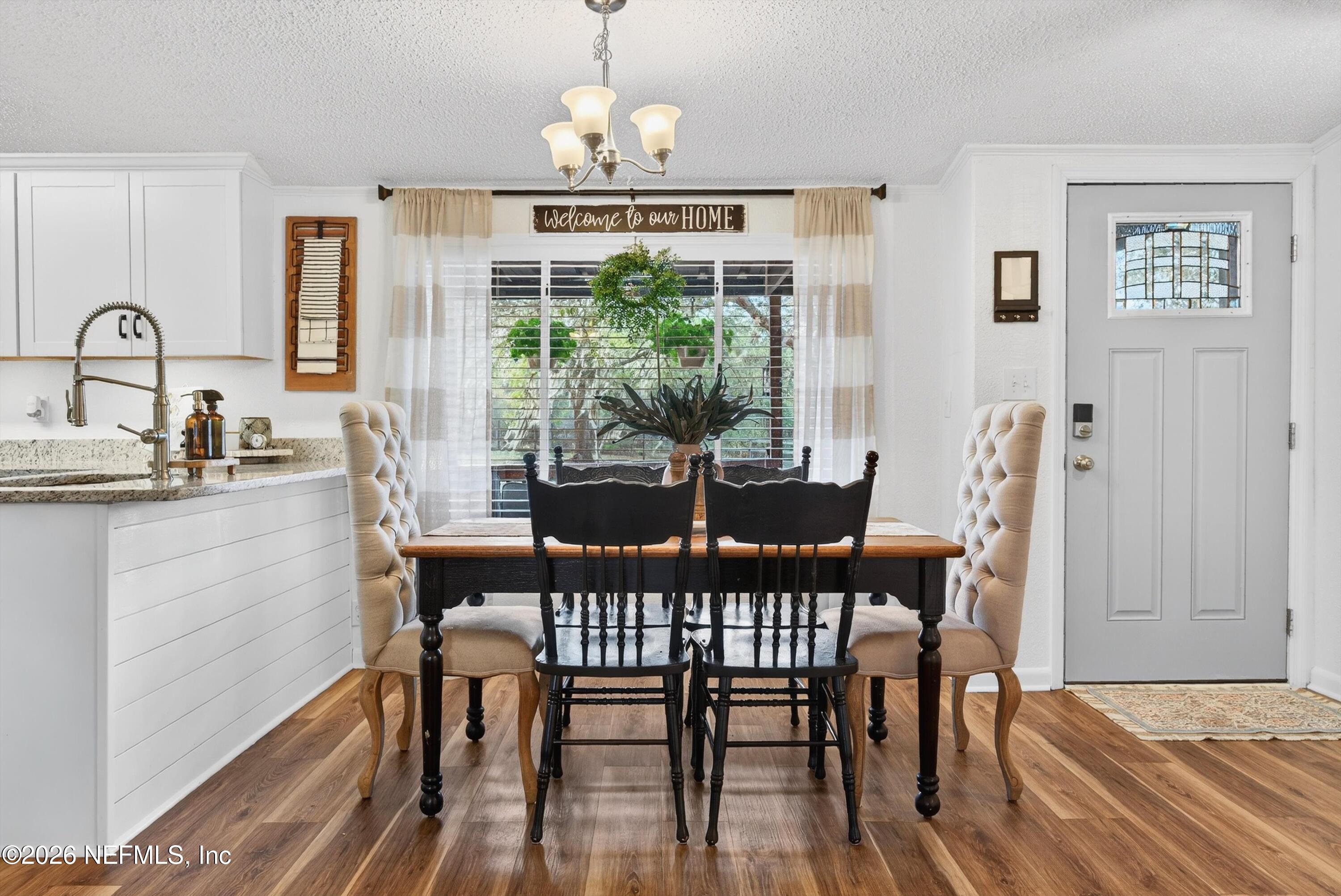 7655 Long Lake Road Keystone Heights, FL 32656 - Photo 7 of 58 a view of a dining room with furniture window and wooden floor