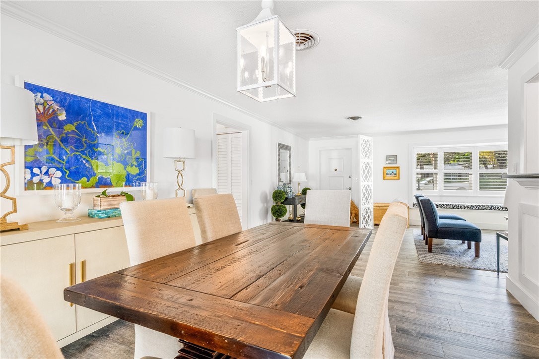 3816 Mockingbird Drive Vero Beach, FL 32963 - Photo 13 of 28 a view of a dining room with furniture a chandelier and wooden floor