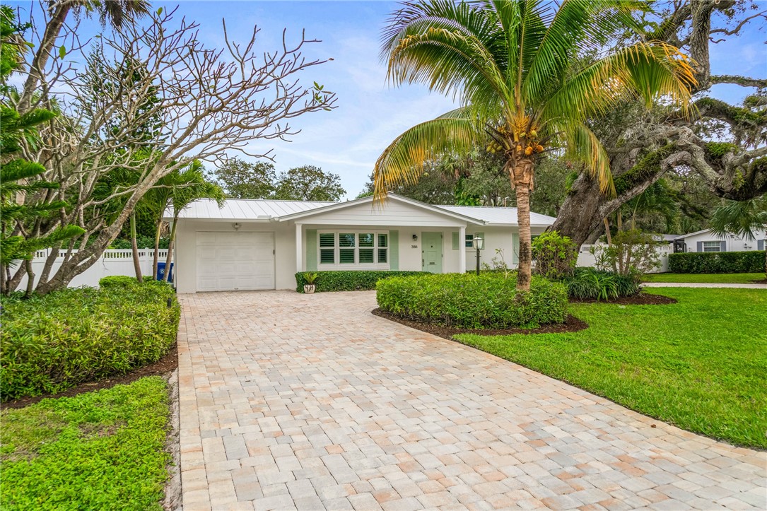 3816 Mockingbird Drive Vero Beach, FL 32963 - Photo 2 of 28 a front view of a house with a garden