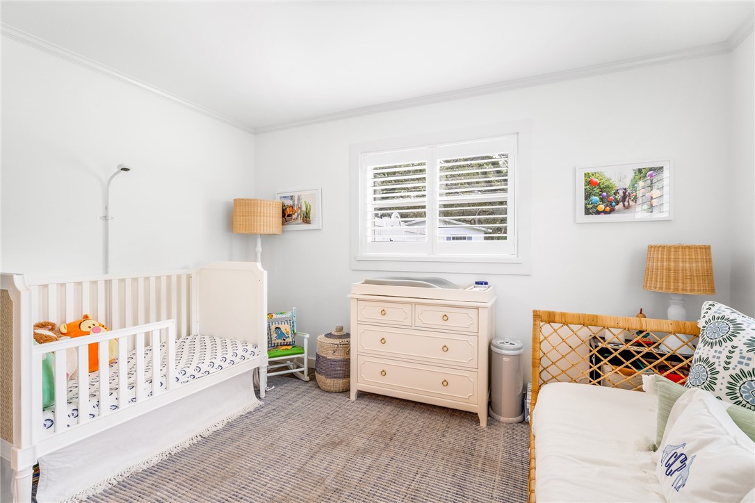 3816 Mockingbird Drive Vero Beach, FL 32963 - Photo 21 of 28 a bedroom with a baby bed baby crib and a couch