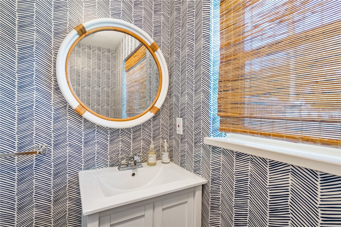 3816 Mockingbird Drive Vero Beach, FL 32963 - Photo 25 of 28 a bathroom with a sink and a mirror