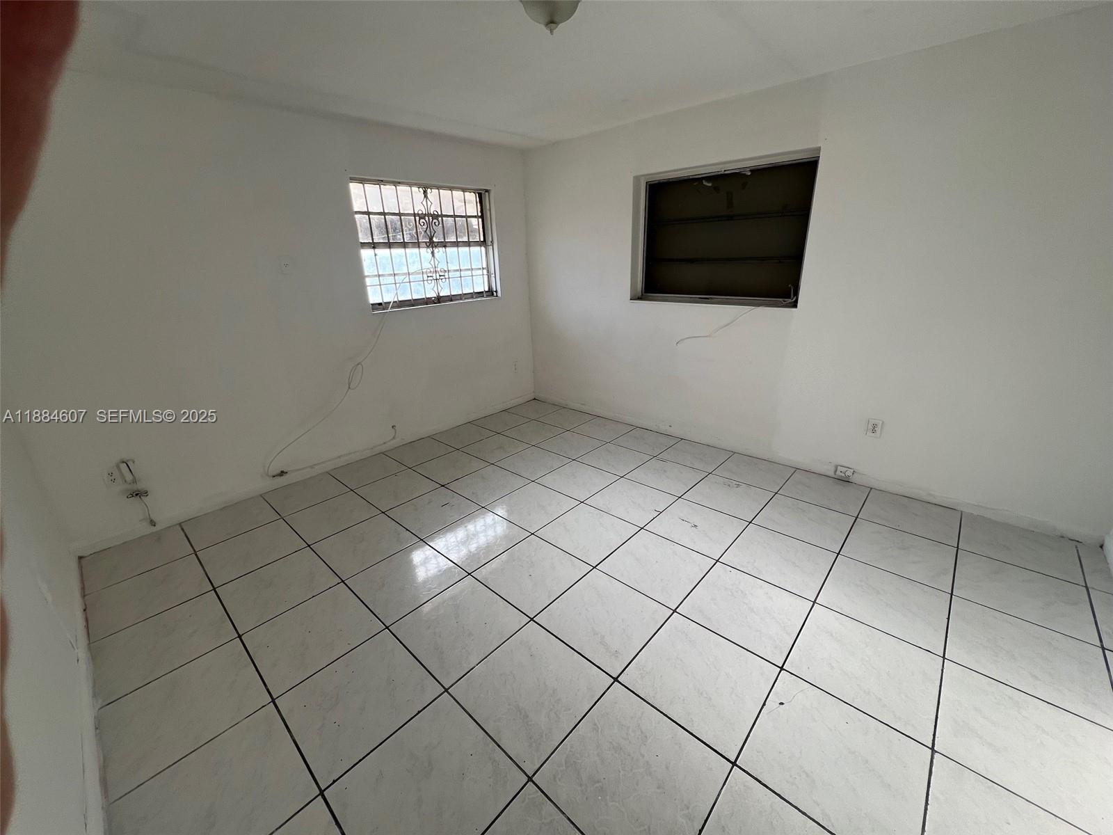 887 West 29th Street, Unit 1 Hialeah, FL 33012 - Photo 5 of 8 a view of an empty room with a window