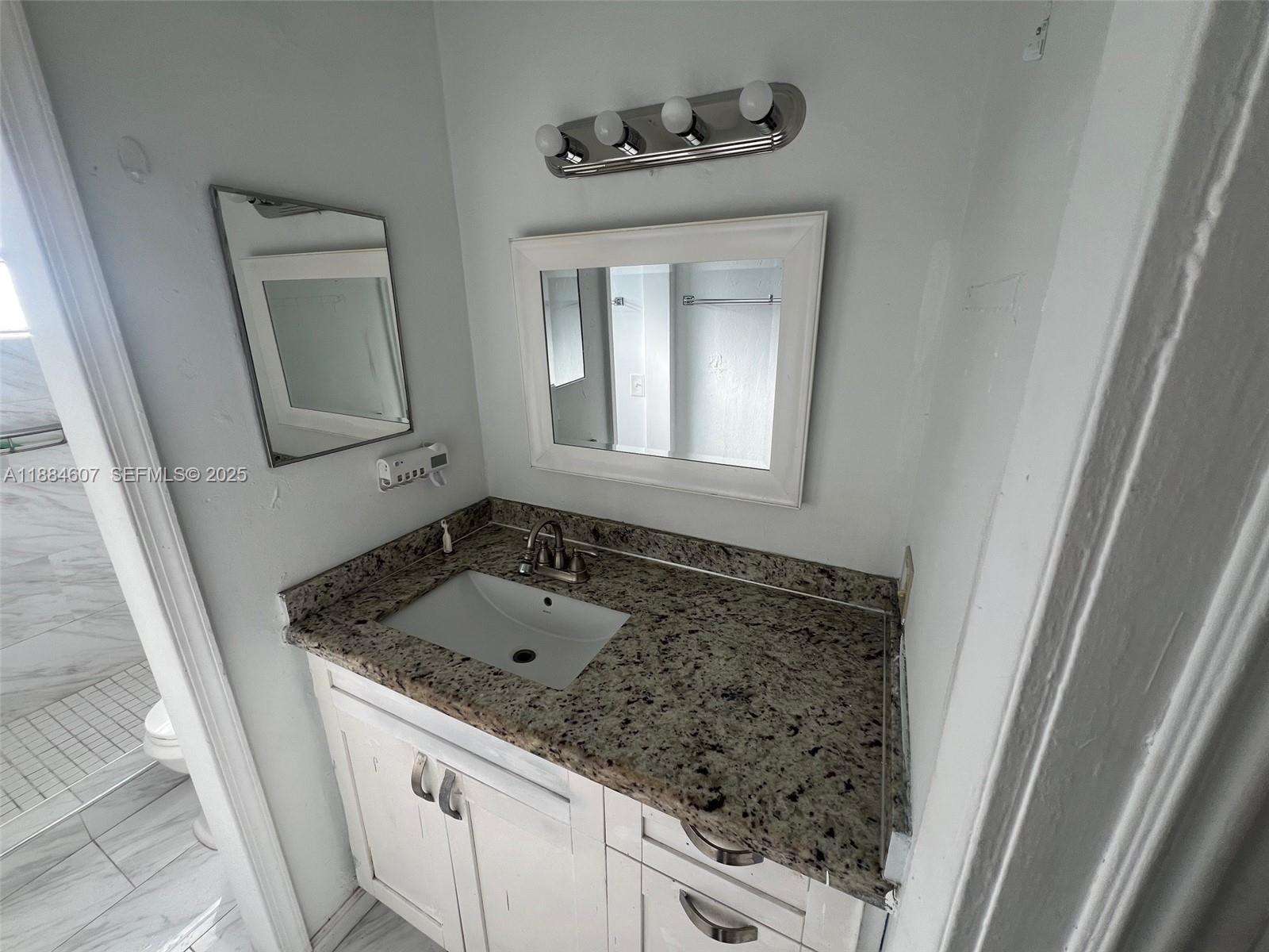 887 West 29th Street, Unit 1 Hialeah, FL 33012 - Photo 7 of 8 a bathroom with a sink and a mirror