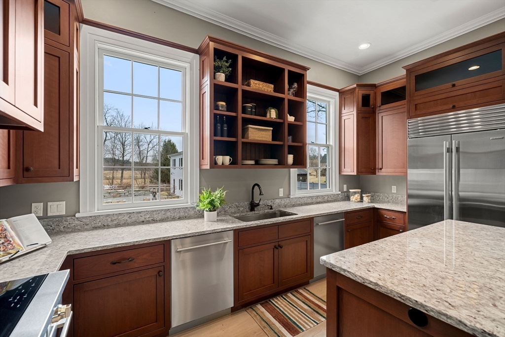 186 Main Street Groton, MA 01450 - Photo 13 of 42 a kitchen with a sink a counter top space and cabinets