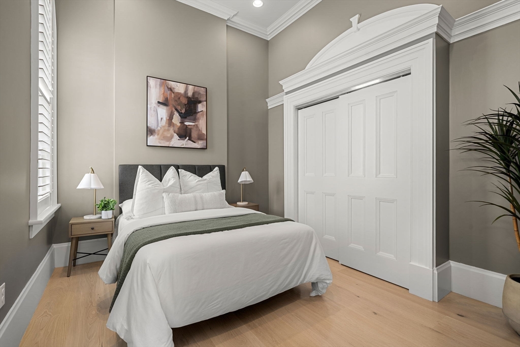 186 Main Street Groton, MA 01450 - Photo 15 of 42 a bedroom with a bed and a painting on the wall