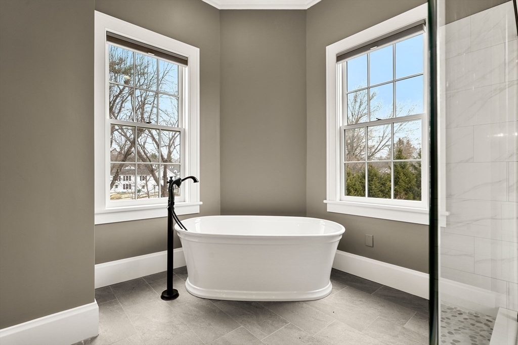 186 Main Street Groton, MA 01450 - Photo 24 of 42 a white bath tub sitting in a bathroom next to a window