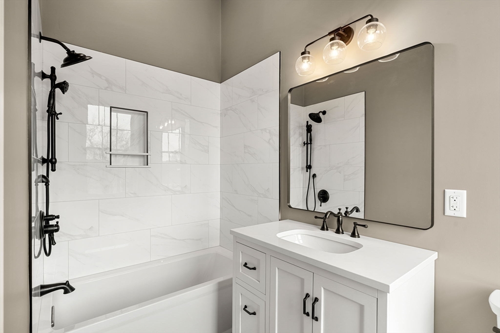 186 Main Street Groton, MA 01450 - Photo 28 of 42 a bathroom with a sink vanity tub and shower