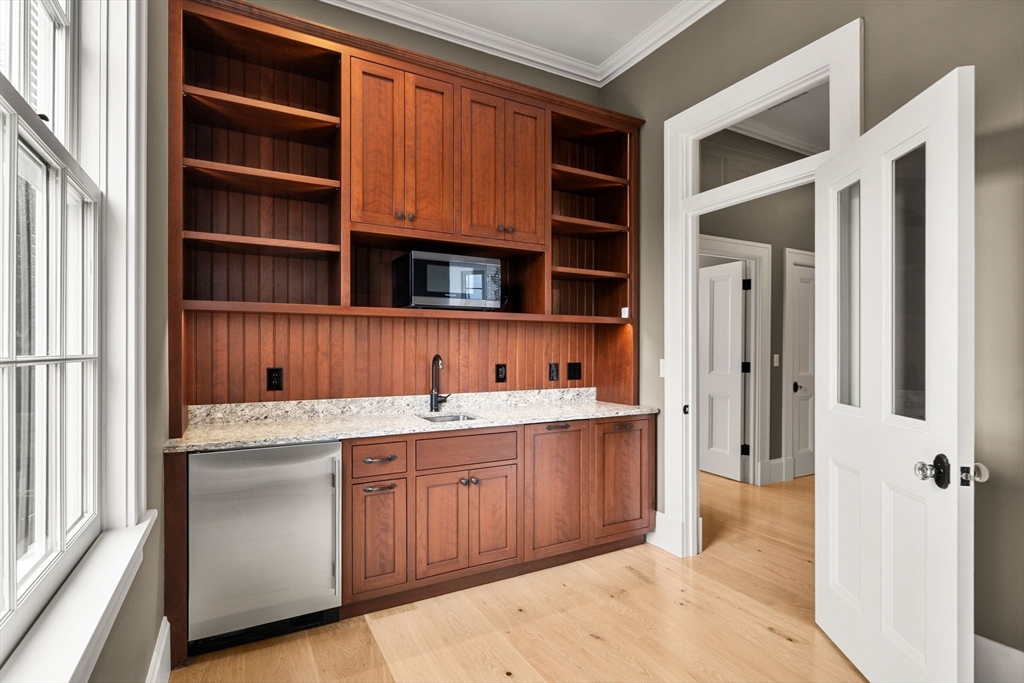 186 Main Street Groton, MA 01450 - Photo 29 of 42 a view of cabinets a window and a refrigerator