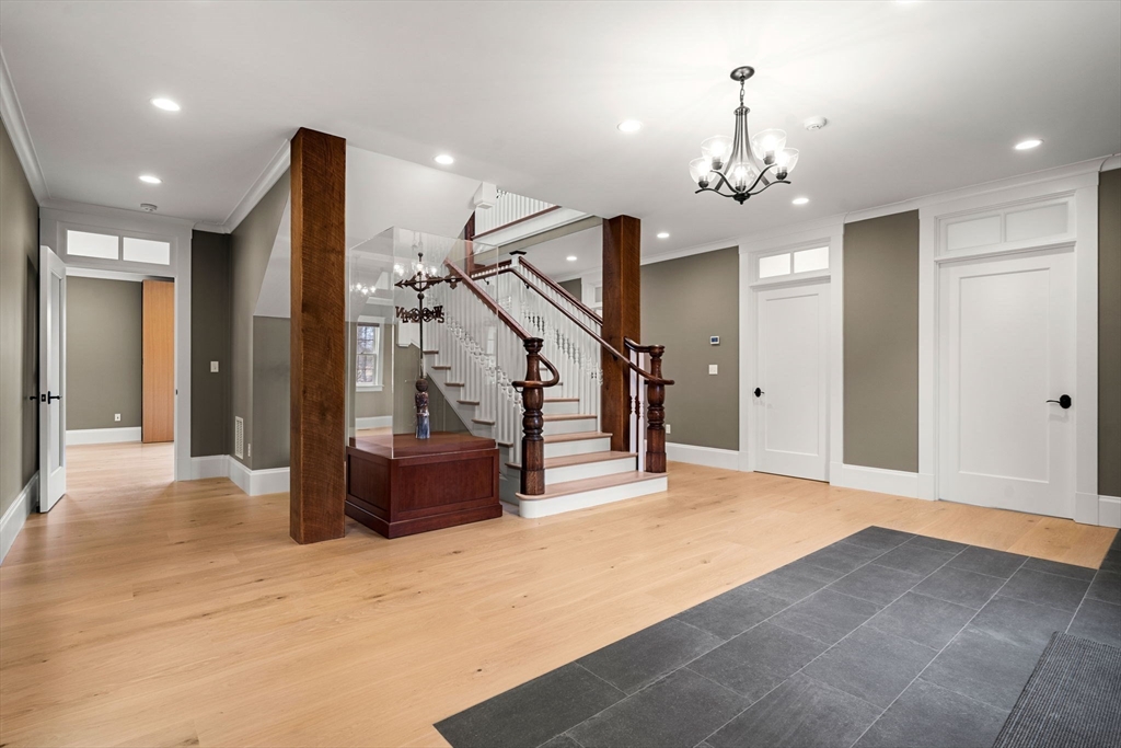 186 Main Street Groton, MA 01450 - Photo 34 of 42 a view of a hallway with a chandelier