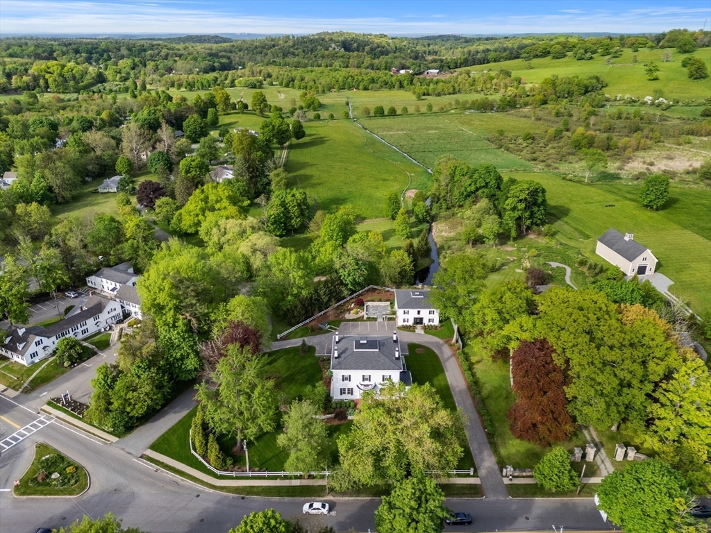186 Main Street Groton, MA 01450 - Photo 40 of 42 an aerial view of residential houses with outdoor space and trees