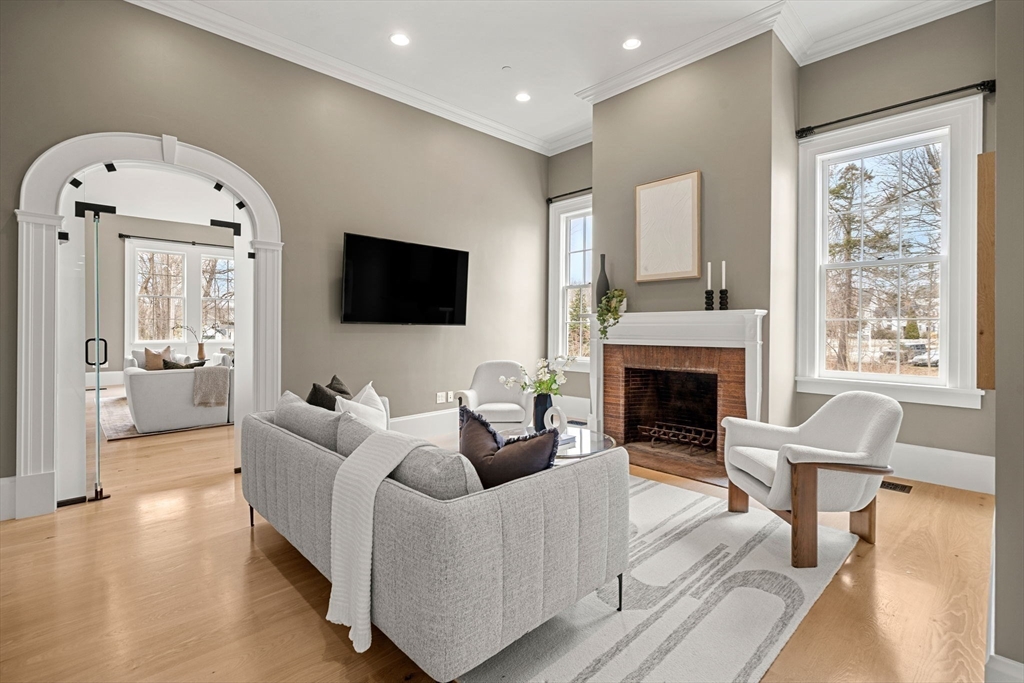 186 Main Street Groton, MA 01450 - Photo 7 of 42 a living room with furniture a fireplace and a flat screen tv