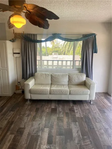 a living room with furniture and a floor to ceiling window