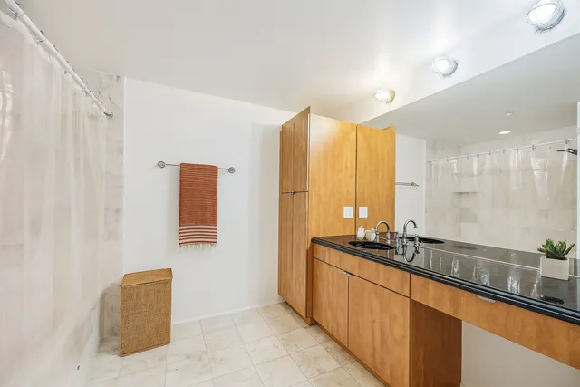 a large bathroom with a double vanity sink and a large mirror