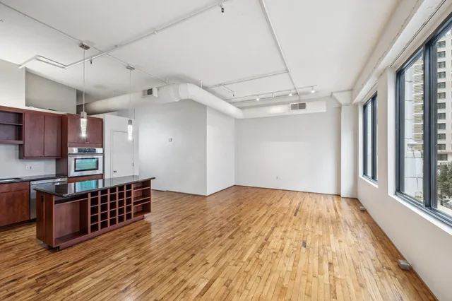 a view of a room with wooden floor