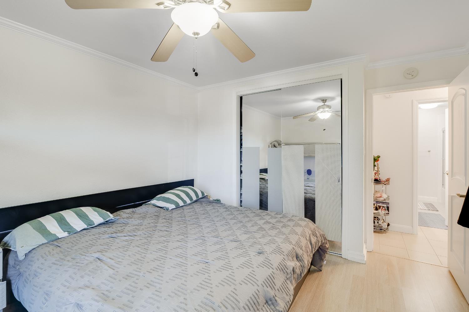 1699 Laguna Street, Unit 302 Concord, CA 94520 - Photo 18 of 30 a bedroom with a bed and a chandelier