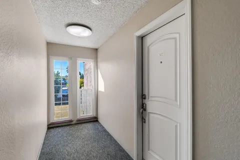 a view of a hallway with wooden floor