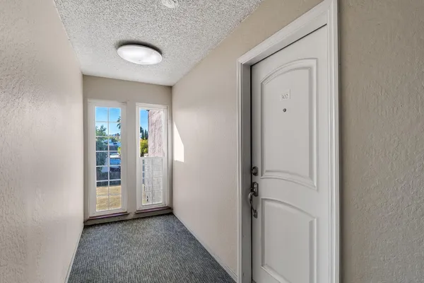 a view of a hallway with wooden floor