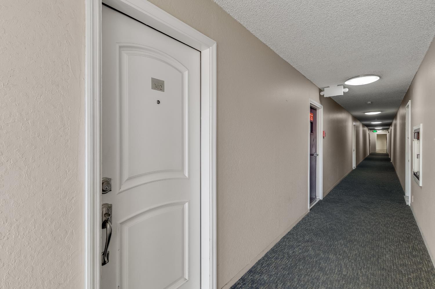 1699 Laguna Street, Unit 302 Concord, CA 94520 - Photo 6 of 30 a view of a hallway with wooden floor