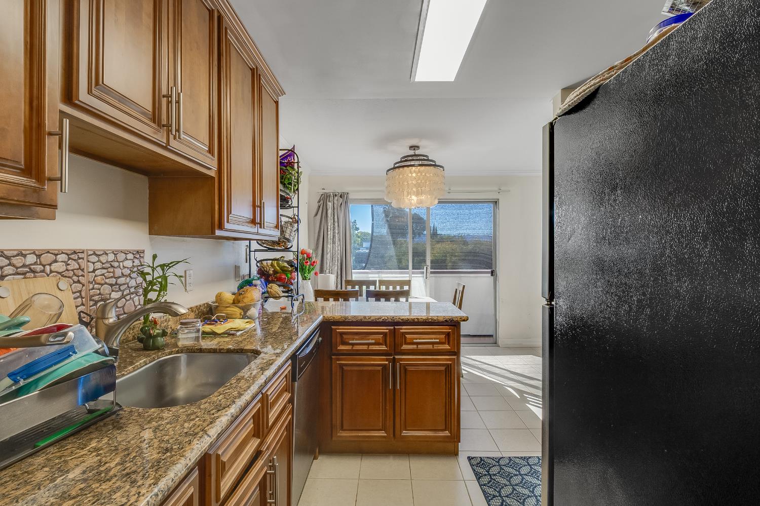 1699 Laguna Street, Unit 302 Concord, CA 94520 - Photo 9 of 30 a kitchen with a sink and a refrigerator