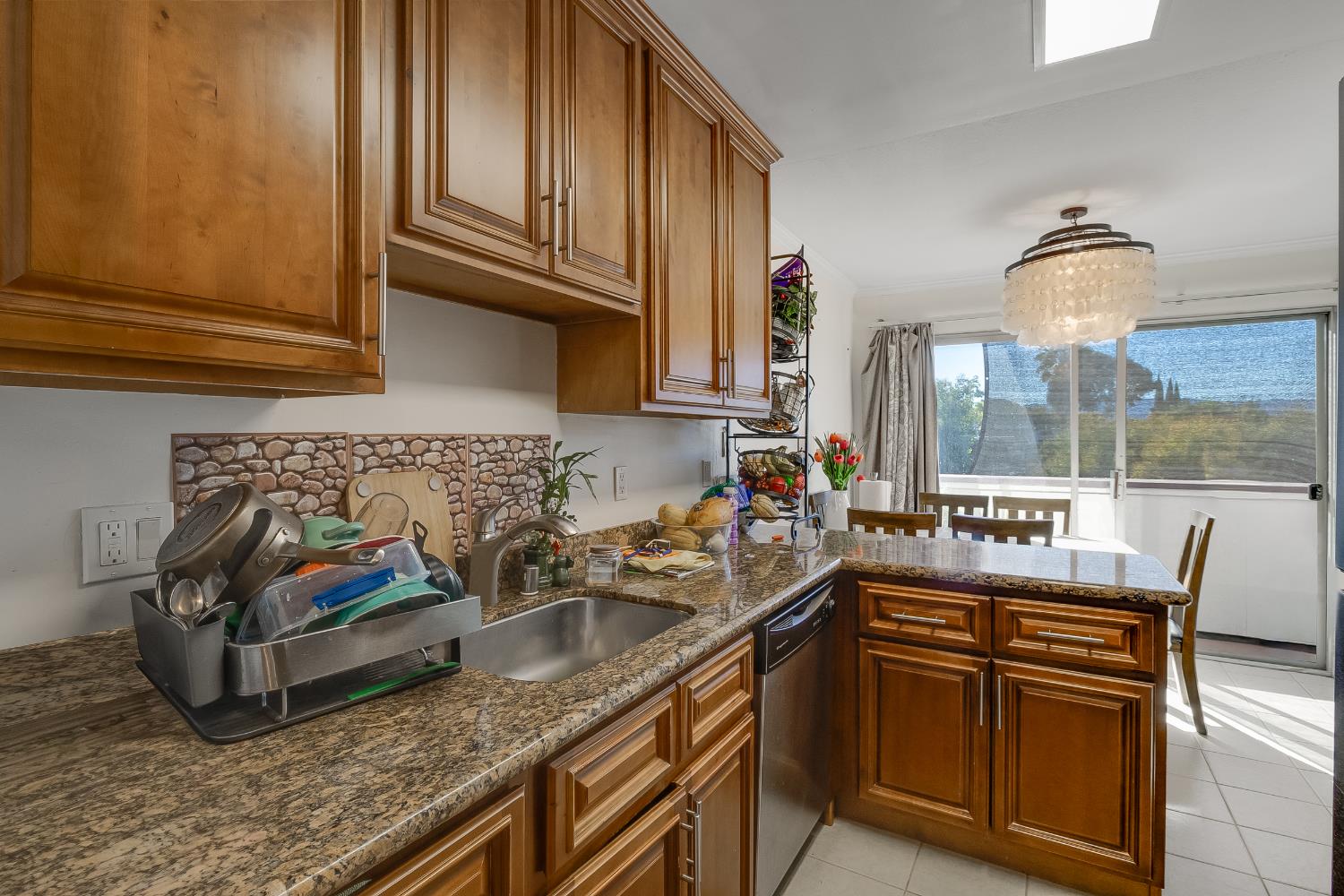 1699 Laguna Street, Unit 302 Concord, CA 94520 - Photo 10 of 30 a kitchen with granite countertop a sink a stove and cabinets