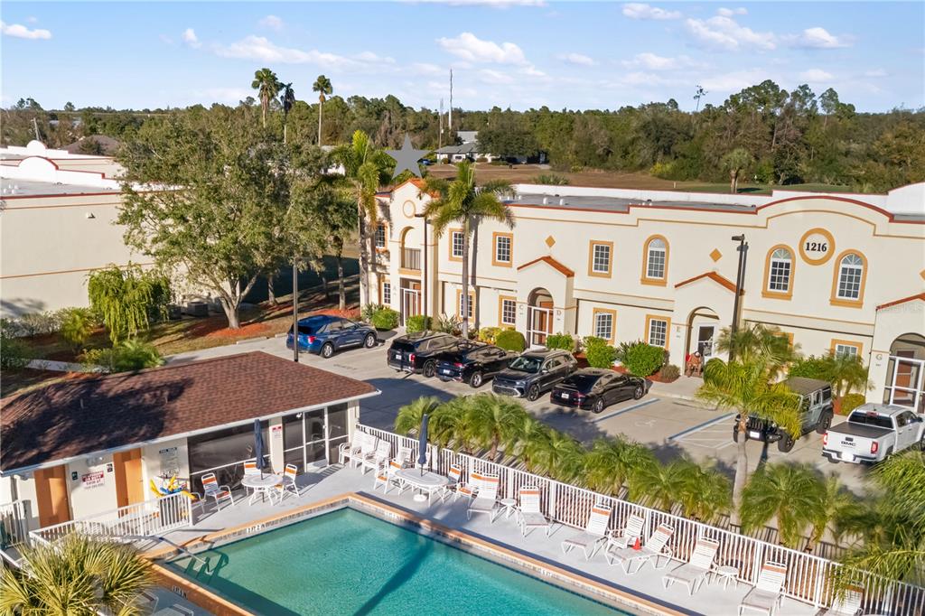 a front view of building with yard and outdoor seating