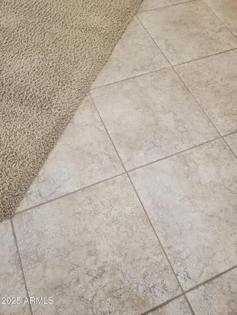 en empty room with windows and ceiling fan
