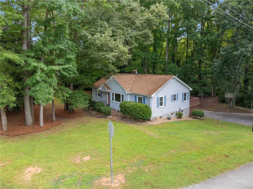 98 Blue Ridge Drive Clemson, SC 29631 - Photo 4 of 32 Mature trees frame a charming classic home nestled on a gently sloping green lawn.