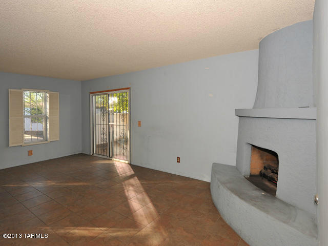 600 East River Road, Unit P Tucson, AZ 85704 - Photo 10 of 28 a view of an empty room with window and fire place