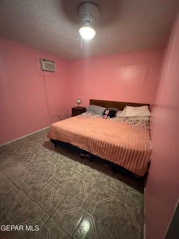 a bedroom with a bed and mirror