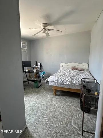 a bedroom with a bed and a mirror