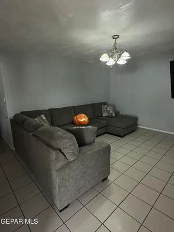 a living room with furniture and a chandelier