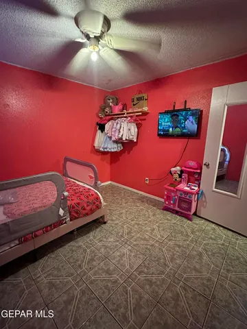 a view of a yard with wooden fence