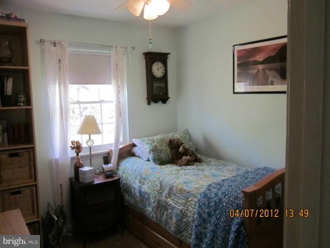 890 Maple Tree Road Severn, MD 21144 - Photo 3 of 15 a bedroom with a bed and a window